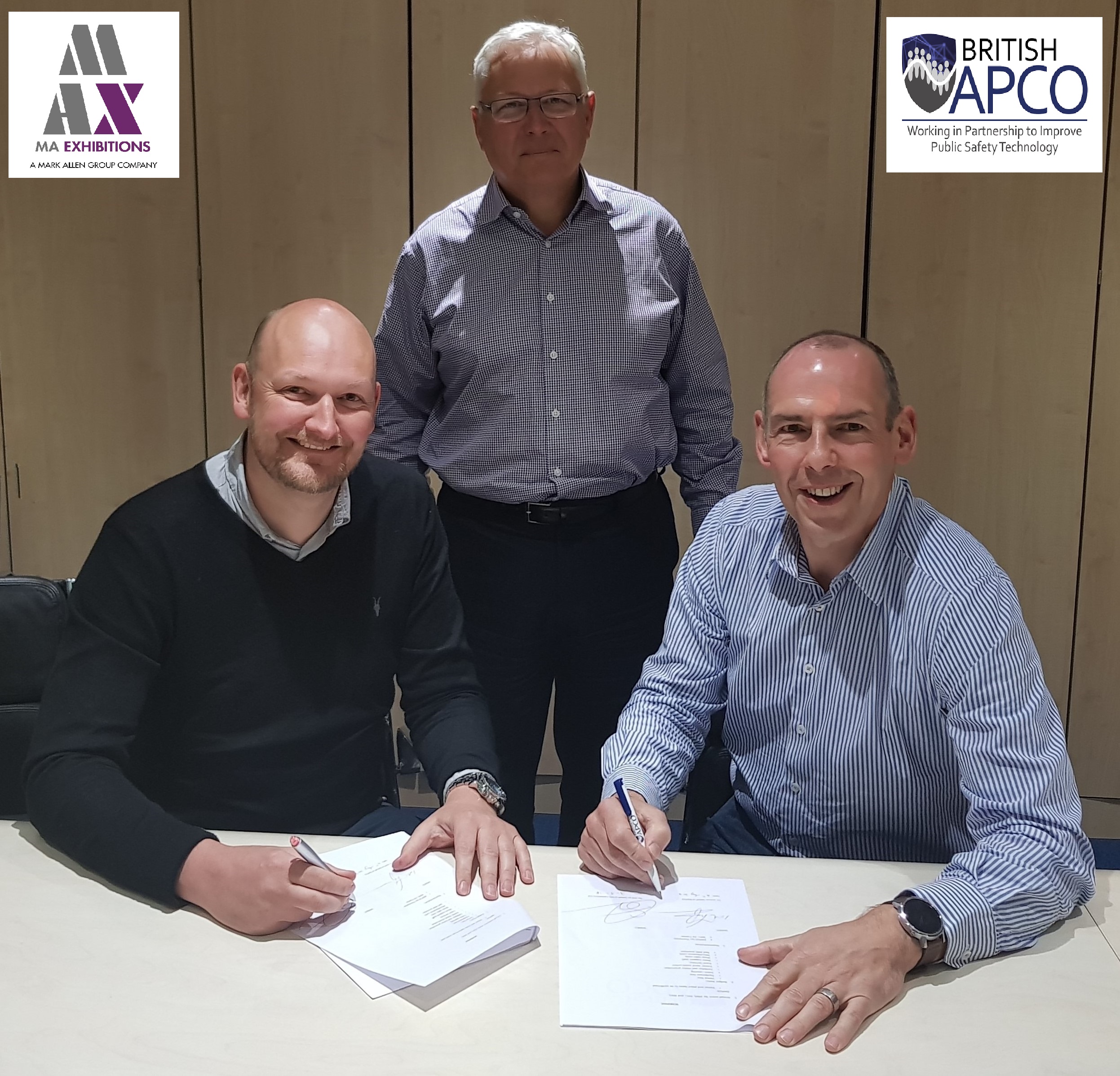President John Anthony looks on as Ed Tranter (MAX) and Ian Thompson (BAPCO) sign the new contract.